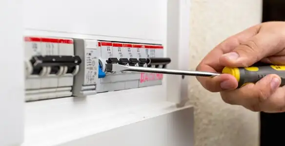 electrical panel upgrade service showing technician adjusting circuit breakers during system upgrade in Staten Island, NY