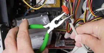 Licensed electrical contractor performing electrical repair with tools in Elizabeth, NJ